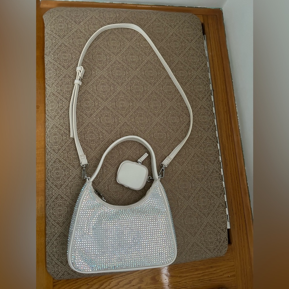 Used white bag with front/side sparkle with inside zipper and credit card pocket